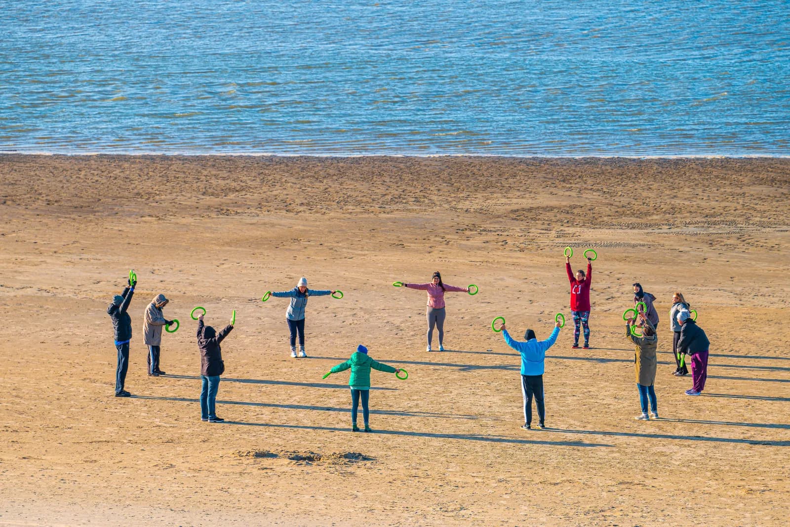 Teams taking part in a collaborative beach activity on the Isle of Wight