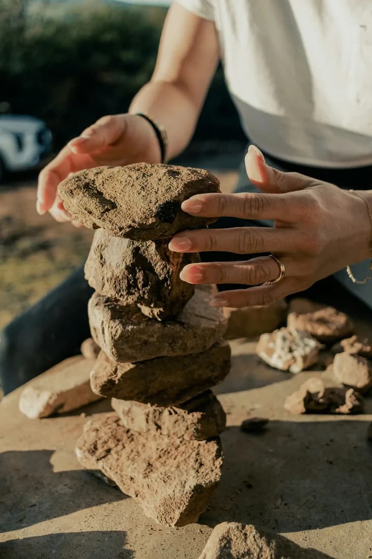 A group taking part in a rock balancing team challenge